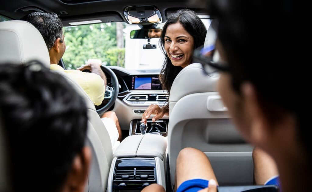 Mother talking to children in car on road trip