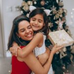 Mother receiving Christmas gift from daughter