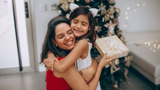 Mother receiving Christmas gift from daughter